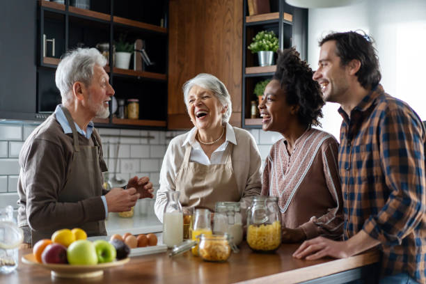 istock Multi generation multiethnic family having fun, talking around a festive kitchen table. 2185723424