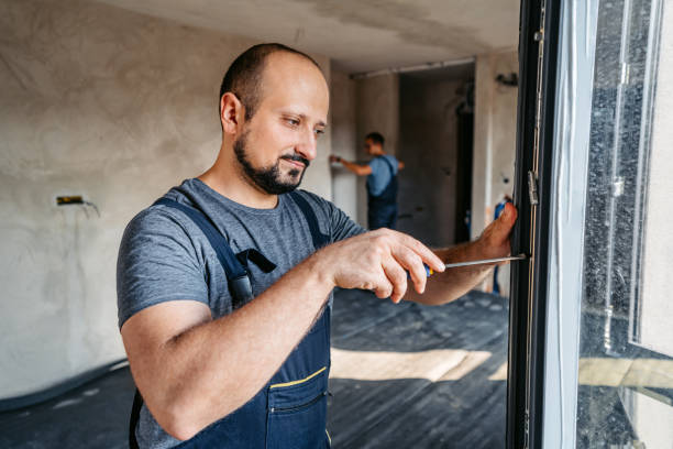 istock Repairman Screwing The Windows In An Empty Apartment Under Renovation 2185723552