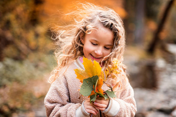 A Child girl having fun on Autumn Forest
