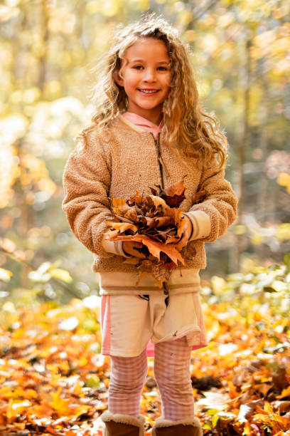 istock Child girl having fun on Autumn Forest 2185724597