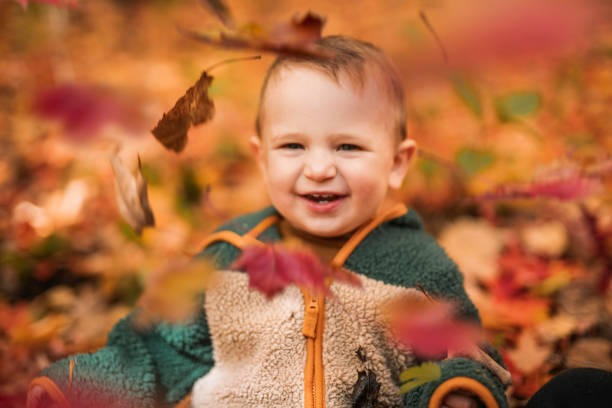 A baby boy having fun on Autumn Forest