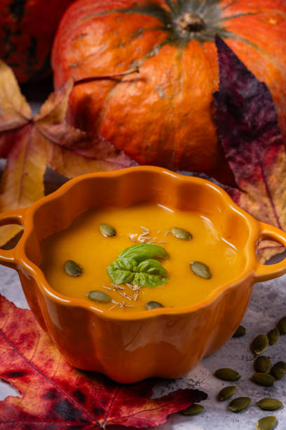 istock Pumpkin cream garnished with seeds and basil leaves 2185725640