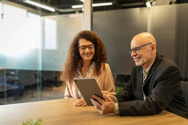 istock Senior employees using tablets in the company 2185728548