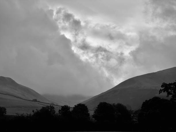 A remote valley in the Lake District National Park against low clouds