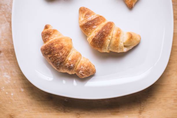 chocolate croissant half cut stuffed with melted chocolate