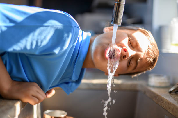 istock Boy drinking water direct from the faucet 2185736312