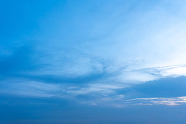 Beautiful cloudscape with fluffy white clouds drifting across a vibrant blue sky