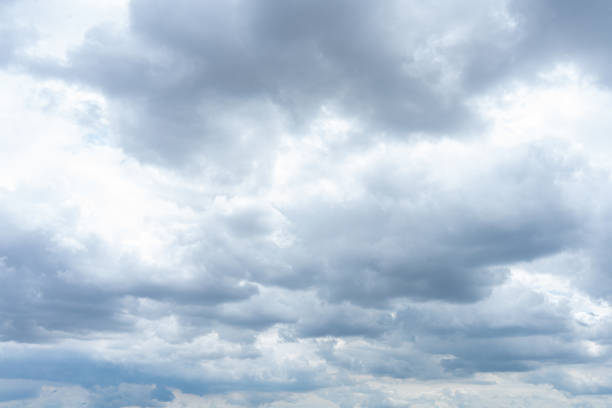 istock Fluffy cumulus clouds drift across a vibrant blue sky 2185746444