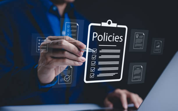 istock Policy documentation and compliance concept. A person reviews digital document labeled 