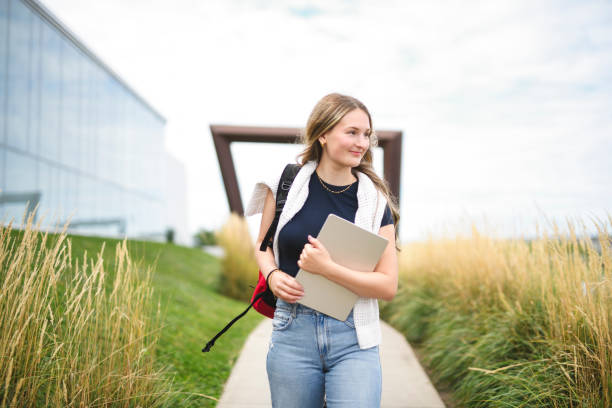 Young girl high school or college student She is on her way to class near university building stock photo