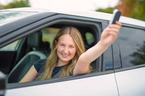istock A beautiful woman with her new car 2185750656