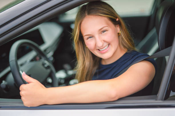 istock A beautiful woman with her new car 2185750662