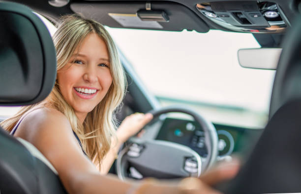 istock A beautiful woman with her new car 2185750692