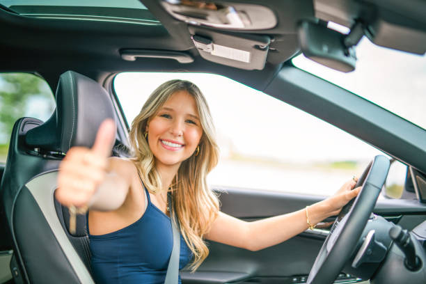 istock A beautiful woman with her new car 2185750699