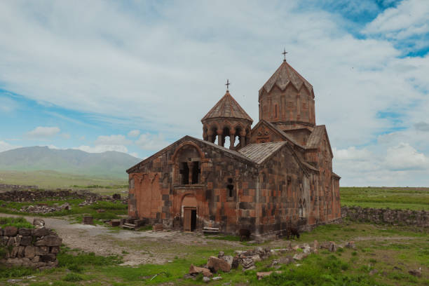 istock Ancient Armenian church surrounded by lush greenery under a cloudy sky in the mountains 2185753092