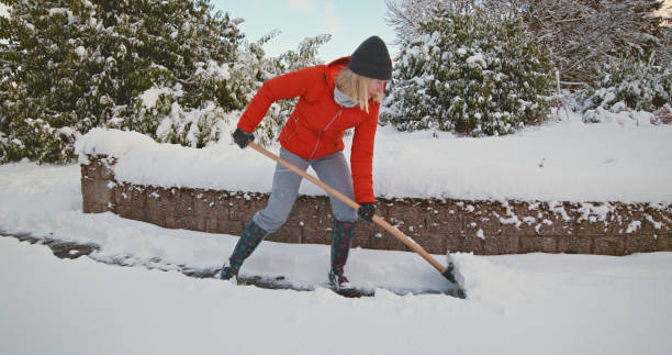 istock Senior woman clearing snow 2185753306