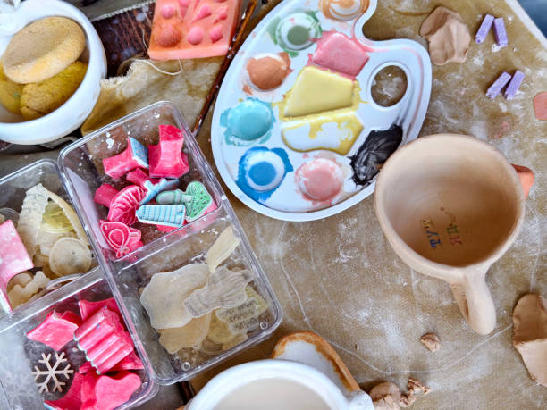 istock Workshop for kids. Children learning how to use clay for making dishes. 2185753334