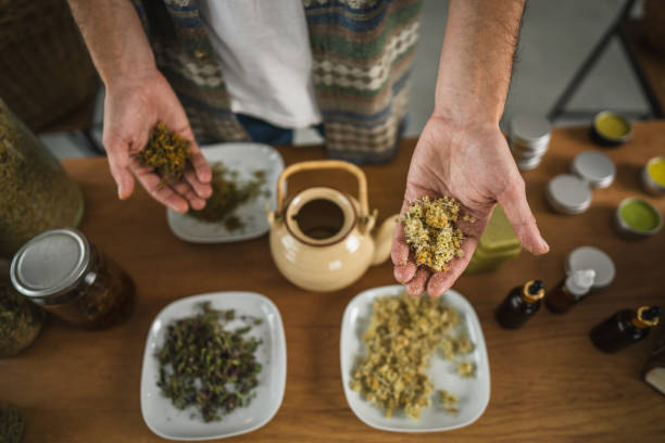 istock close up of man herbalist make a tea from natural herbs at workshop 2185753579
