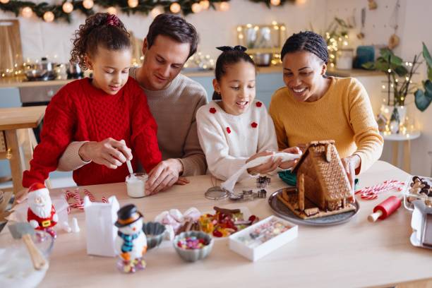 istock Lovely family making Gingerbread house 2185754445