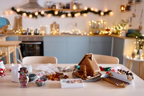 istock Gingerbread house standing on a table in the domestic kitchen 2185754448