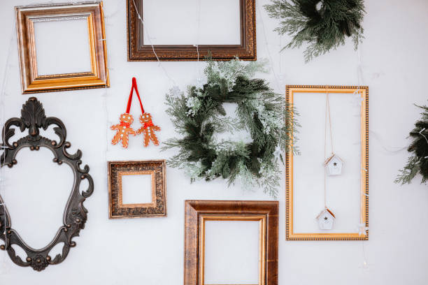 istock Decorative wall with frames, wreath, and ornaments for festive season display 2185755535