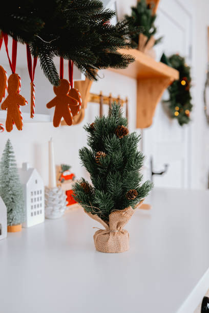 istock Small Christmas tree on table with festive decor and holiday ornaments 2185755562