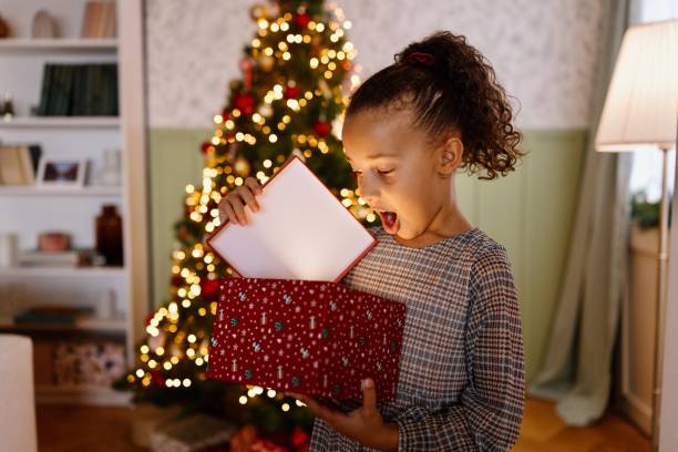 istock Surprised girl opening her Christmas present 2185756029