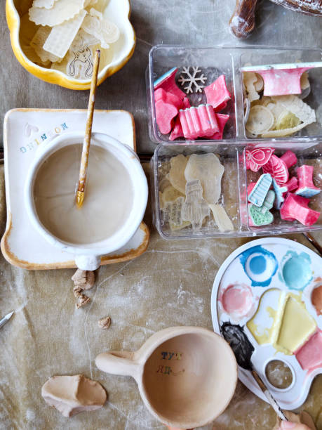 istock Workshop for kids. Children learning how to use clay for making dishes. 2185756882