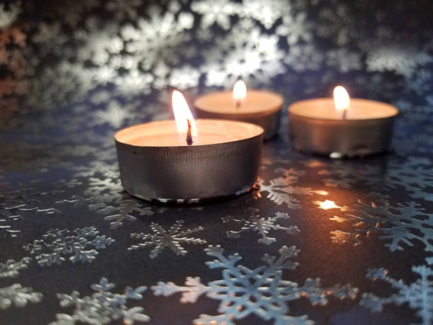 istock Pink tea lights on dark blue background with silver snowflakes 2185759045