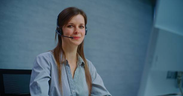 istock Portrait of positive female technical support specialist looking at camera 2185759256