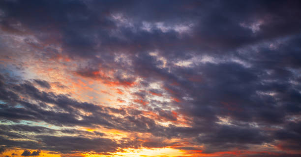 istock Clouds and stormy sky,The sun's rays penetrate through the dark clouds during sunset, panorama,Sunrise background. Dramatic majestic scenery sunset. Sky with clouds in Sunrise sky light background. Sunrise with clouds in various shapes 2185760186