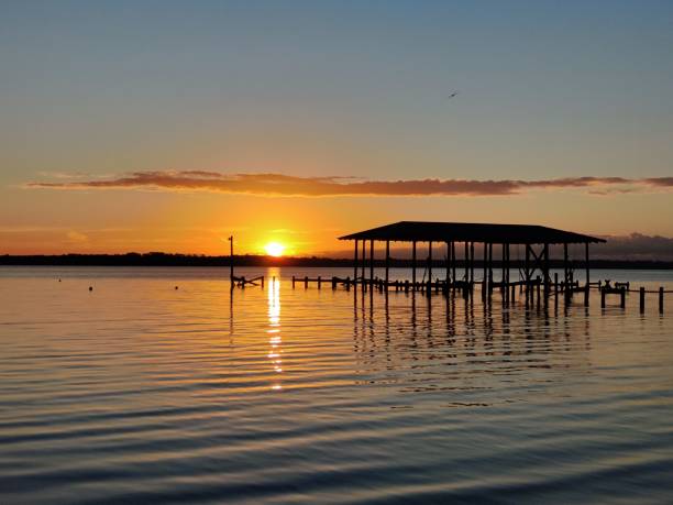 istock Sunset over tranquil lake and dock. 2185762458