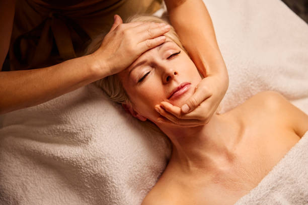 istock Mature Woman Enjoying a Tranquil Face Massage Therapy Session 2185763381