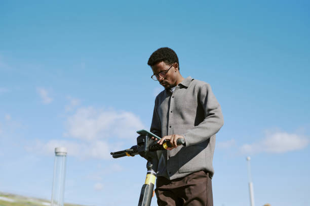 istock Riding Scooter Outdoors Wearing Formal Gray Shirt 2185766081