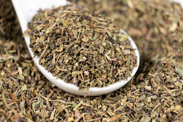 istock Spoon seasoning dry chopped basil close-up 2185766624