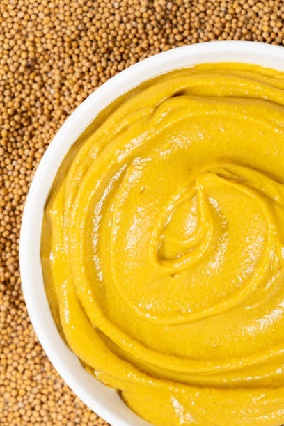 istock Mustard sauce and dry mustard seeds, top view. 2185766657