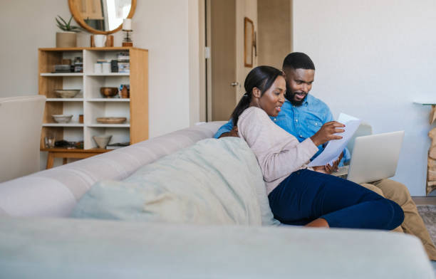 istock Smiling African American couple doing online banking on their sofa 2185768291