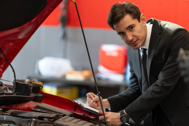 istock Businessman Inspecting Car Engine in Auto Repair Shop 2185770080
