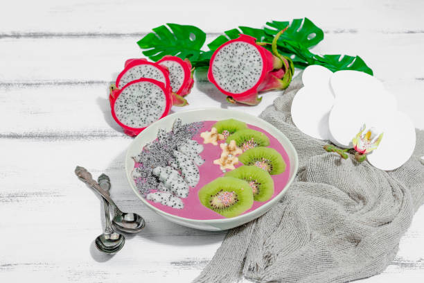 Pitaya smoothie bowl with fruit, kiwi, banana, and poppy seeds. Trendy food, healthy breakfast idea