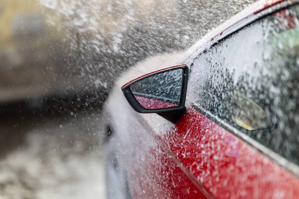 istock Red Car Undergoing a Refreshing Automated Car Wash 2185772240