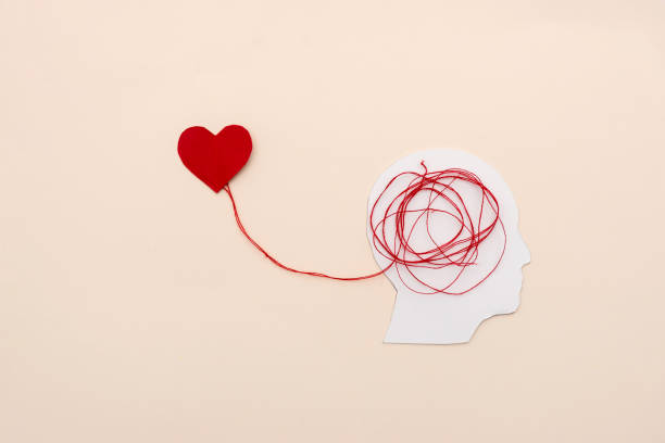 istock Emotional Connection between Brain and Heart with Red Threads on beige Background, mental health concept 2185772426