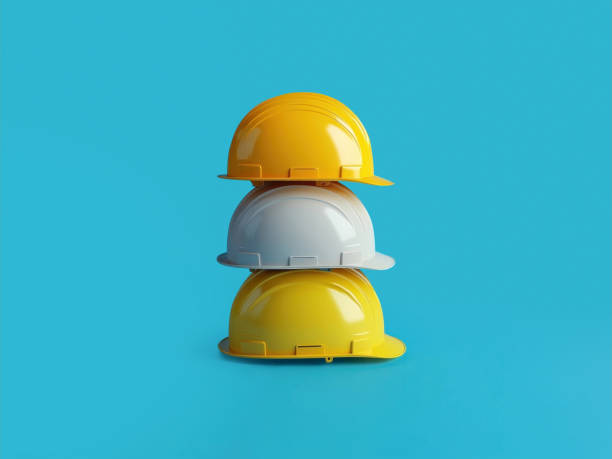 istock Minimalist composition featuring colorful hard hats stacked against a striking blue backdrop, ideal for construction, safety, and industrial themes. 2185773327