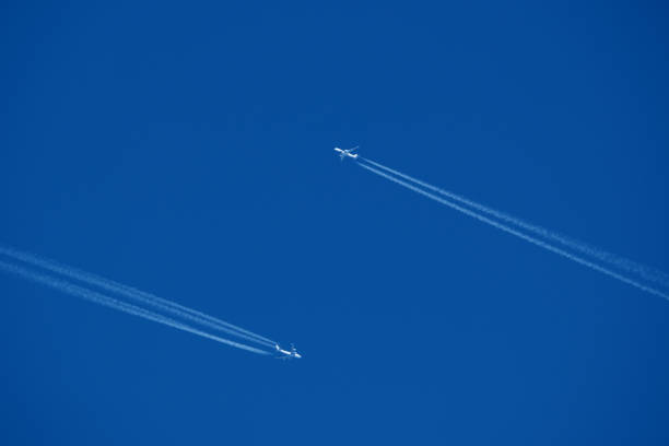 istock Airplanes in the blue sky with contrails. 2185773373