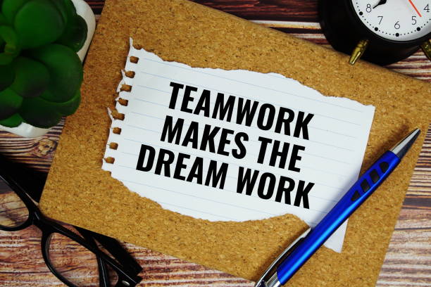 istock Teamwork Makes the Dream Work text written on paper torn top view on wooden background 2185773604