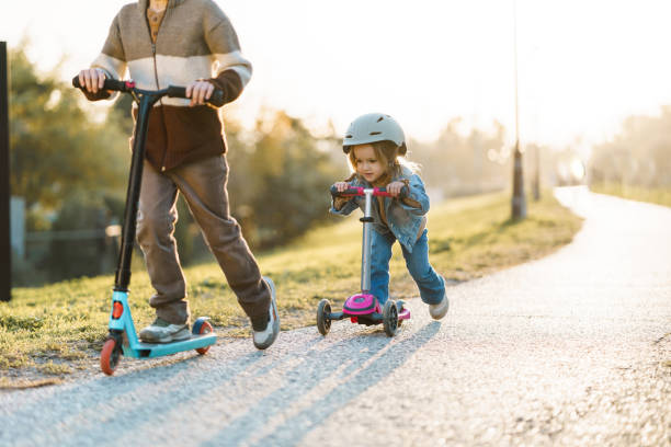 istock A boy and a girl drive push scooters 2185775780