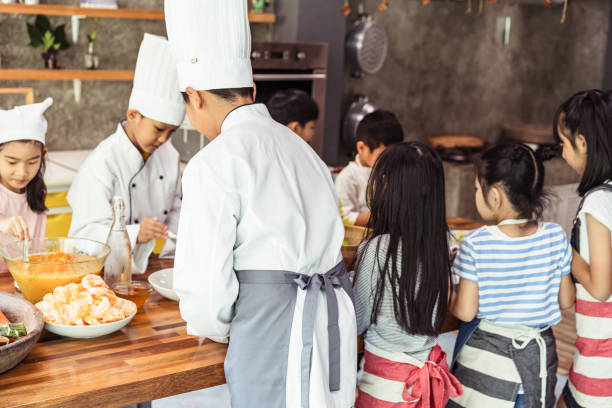 istock Childhood students and friends learning how to cooking in kitchen at school class education 2185776552
