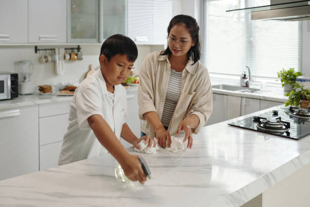 istock Teaching Household Chores to Young Boy in Kitchen 2185776952