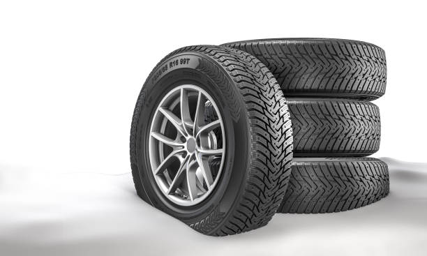 Minimalist display of three black car tires stacked together in a clean studio setting.