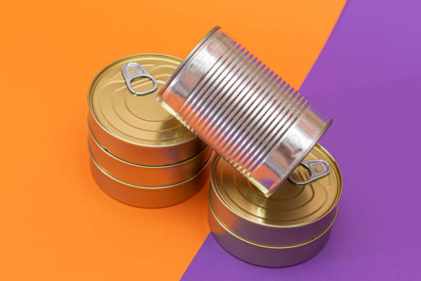 istock A Group of Stacked Tin Cans with Blank Edges on Split Orange and Violet Background 2185778449