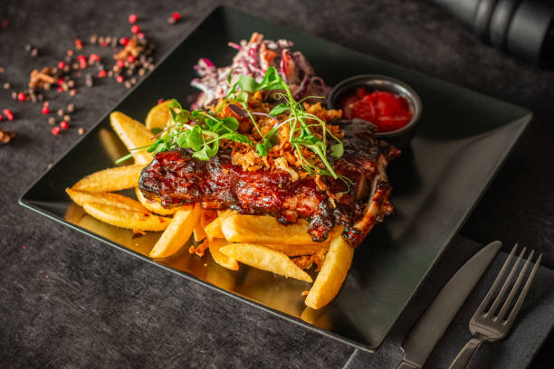 A plate with BBQ ribs garnished with microgreens